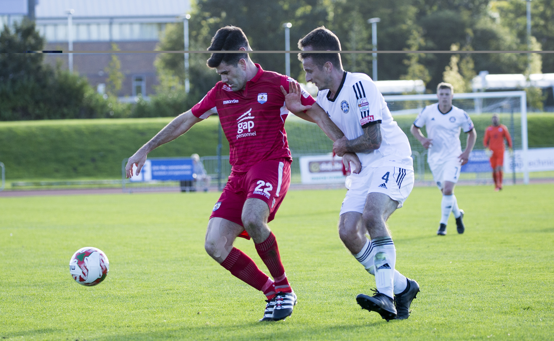 Goalscorer Michael Wilde holds off Mike Sharples - © NCM Media