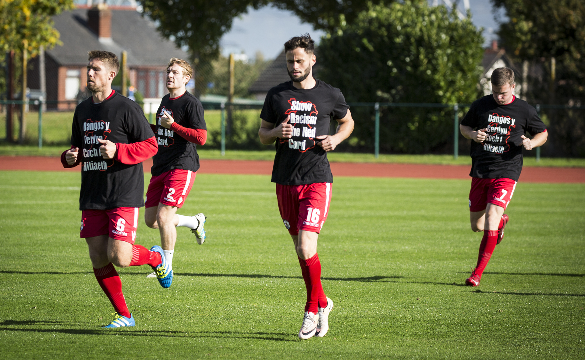 The Nomads warmed up ahead of kick off in their Show Racism the Red Card t-shirts - © NCM Media