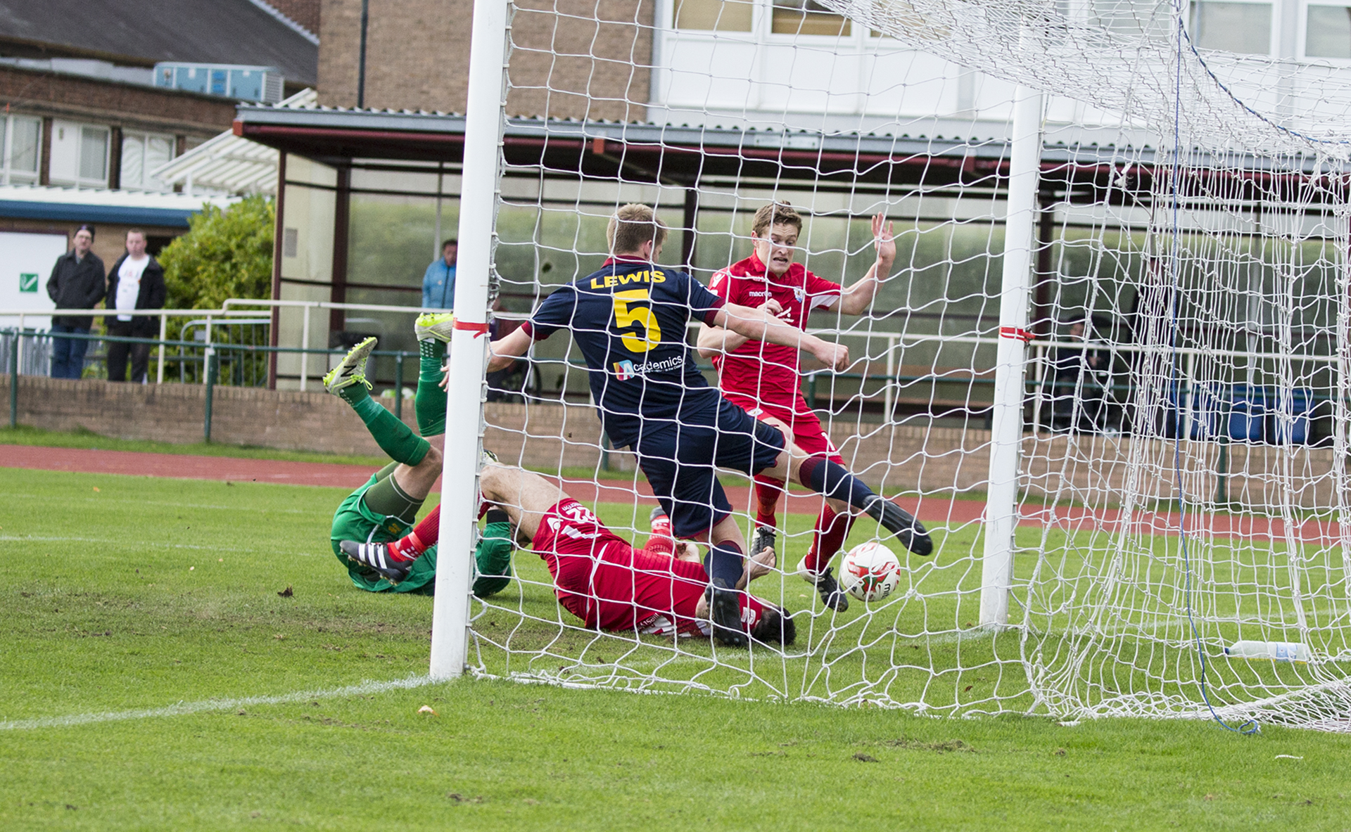 Emlyn Lewis clears off the line for Cardiff Met - © NCM Media