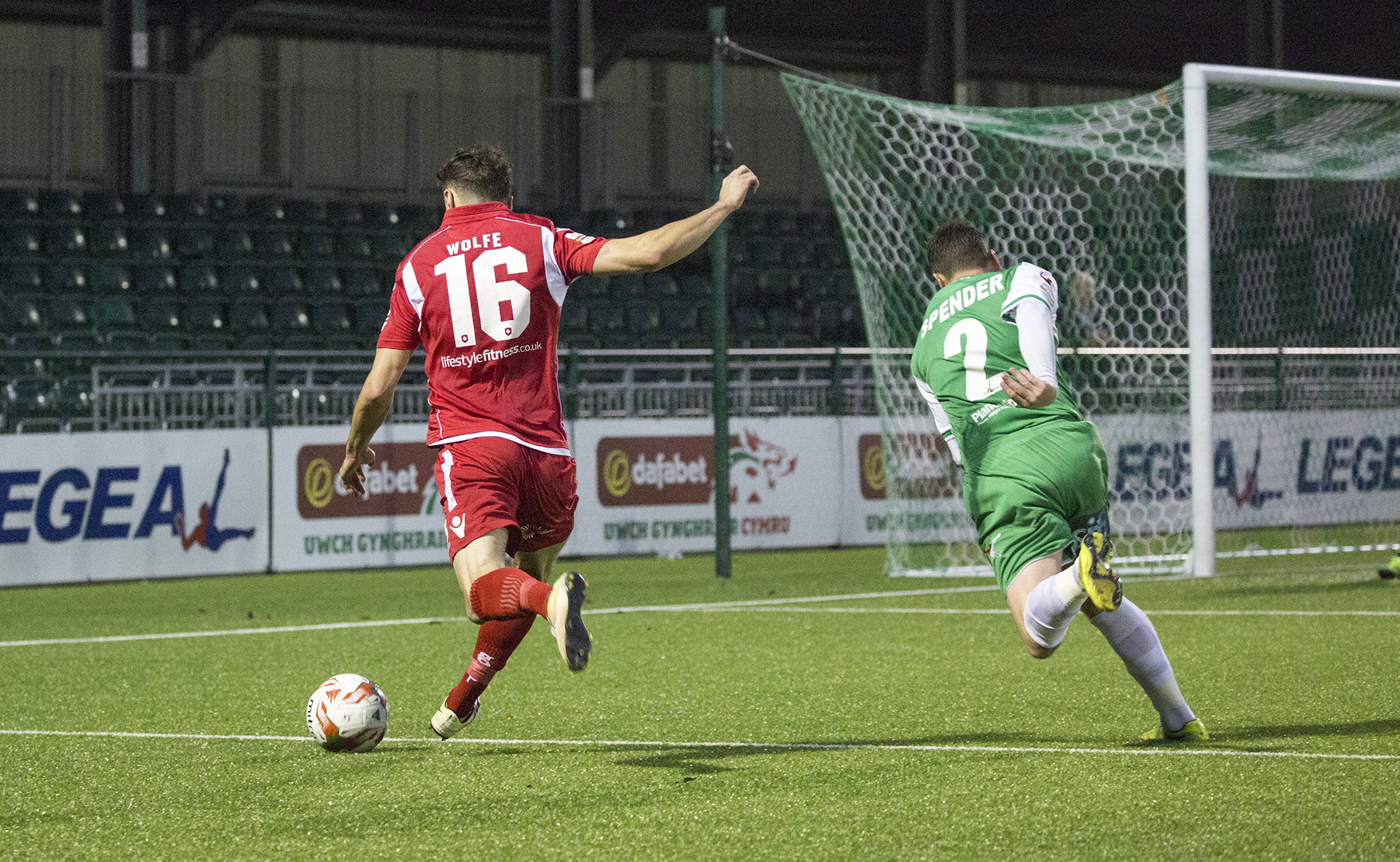 Nathan Woolfe bests Simon Spender to send a cross into the TNS box - © NCM Media