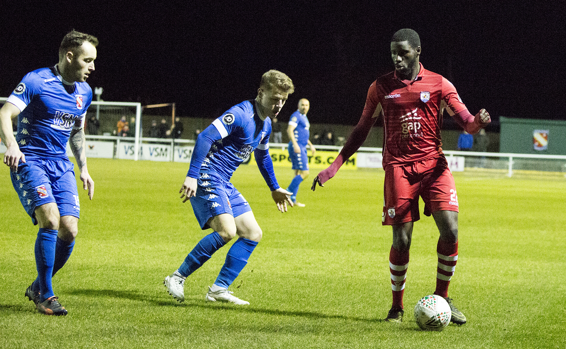 Michael Bakare faces the resolute Bangor City defence - © NCM Media