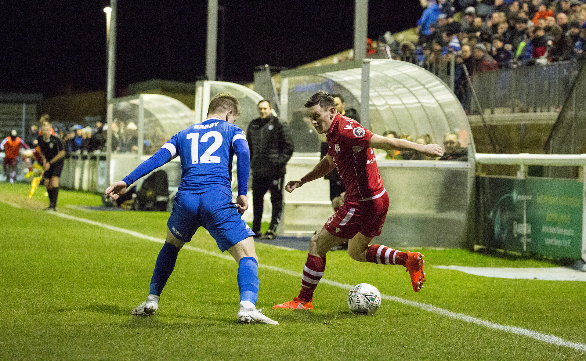 Sean Smith looks to get beyond Bangor's George Harry - © NCM Media