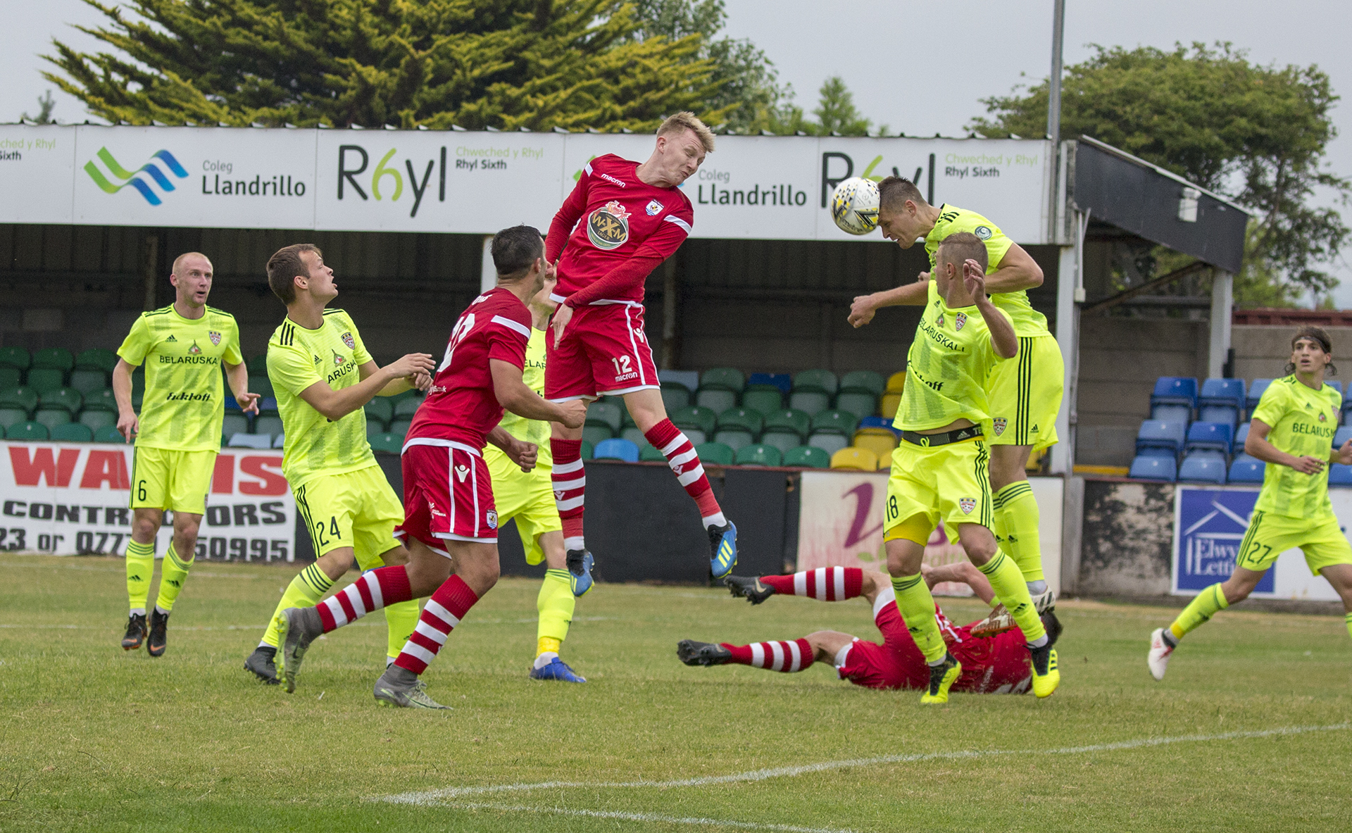 As Declan Poole challenge for the ball, George Horan goes down in the background, for which, The Nomads were awarded a penalty © NCM Media