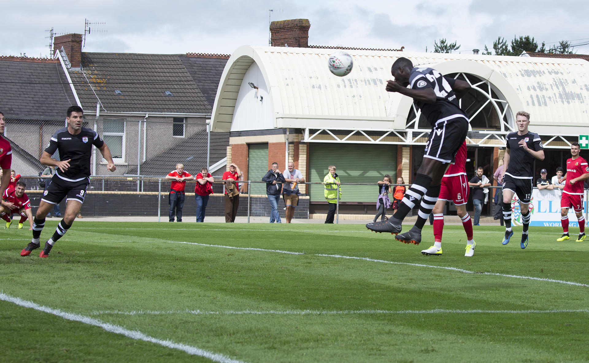 Michael Bakare rises to score the first of his brace on the day © NCM Media