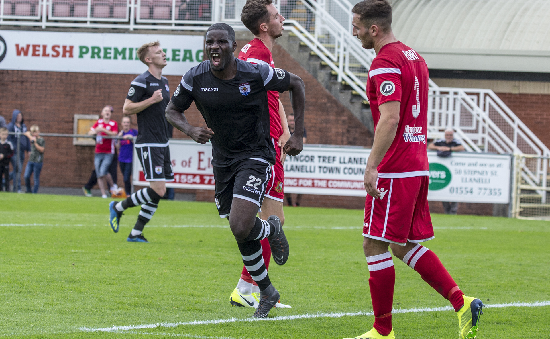 Michael Bakare celebrates his second goal against Llanelli Town © NCM Media