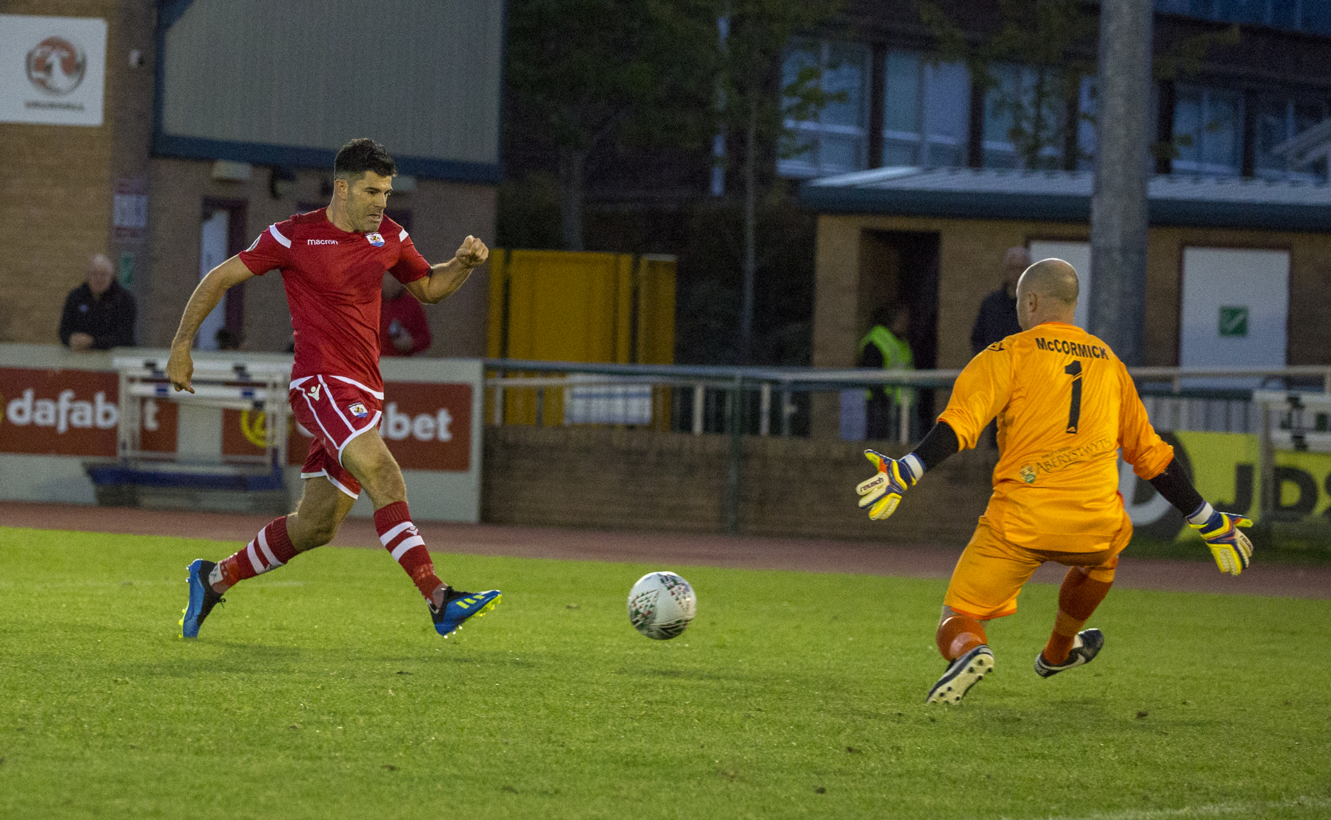 Michael Wilde slots beyond Terry McCormick for The Nomads' second goal of the night © NCM Media