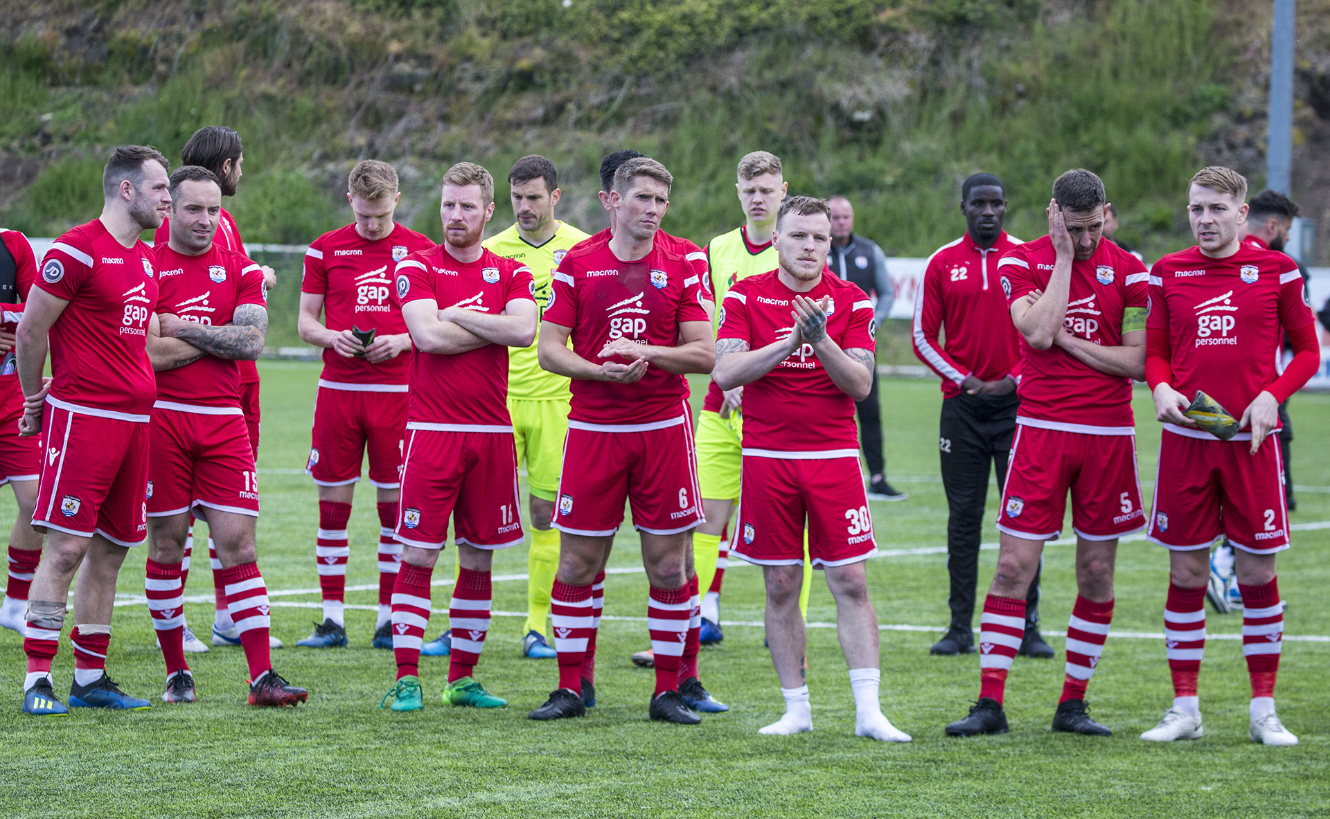 Nomads players look on as TNS receive the trophy | © NCM Media