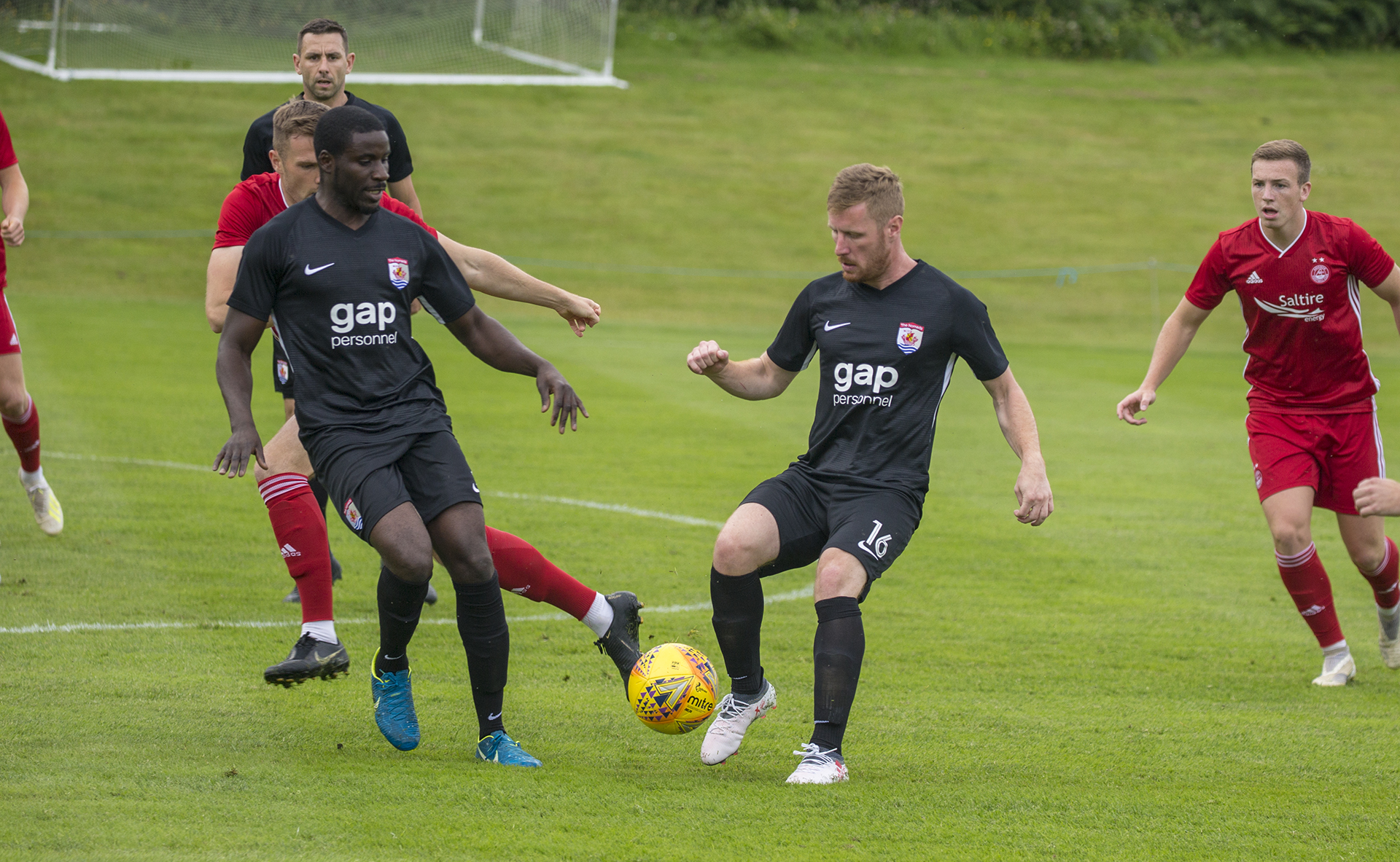 Michael Bakare (left) and Jay Owen (right) look to keep possession during a first half attack | © NCM Media