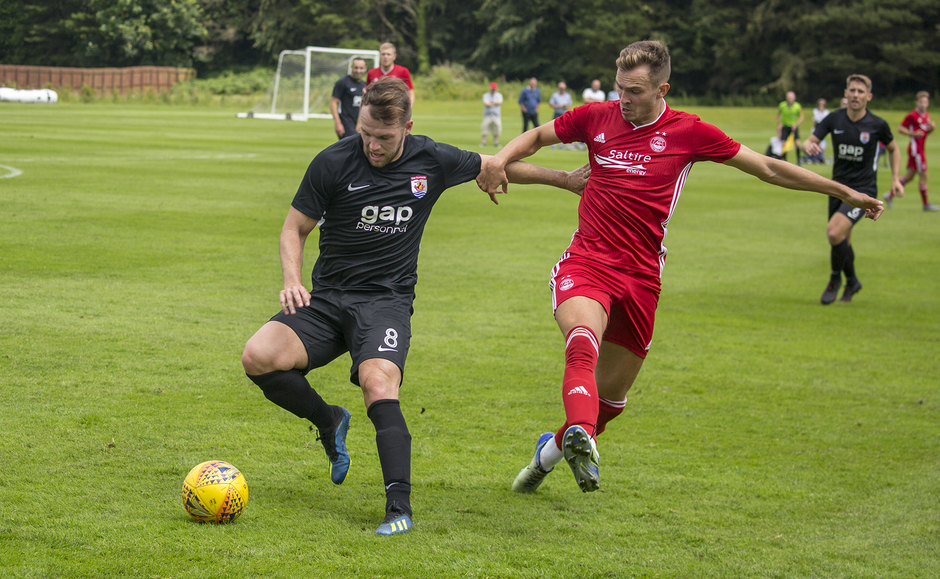 Callum Morris (left) battles with ex Flint Town United player, Ryan Hedges | © NCM Media