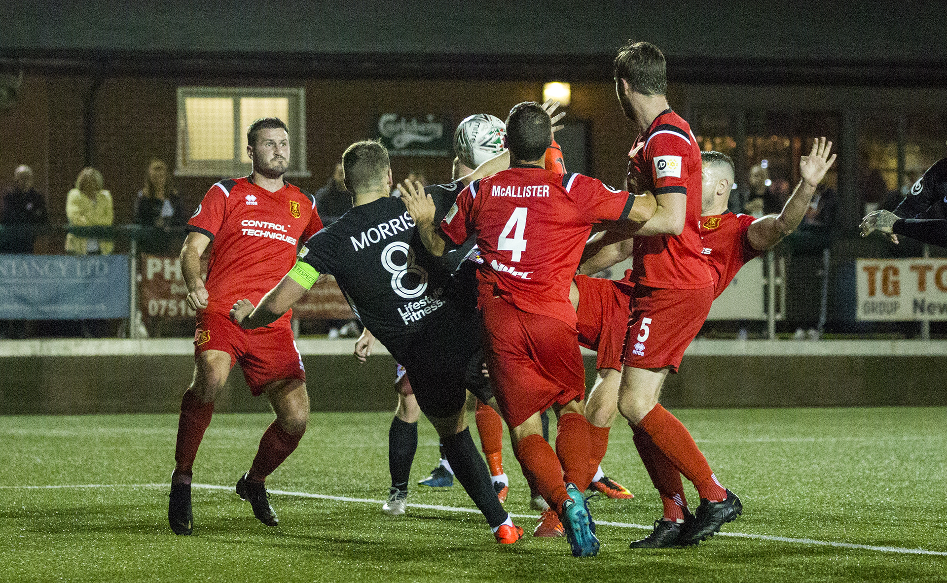 Callum Morris attempts to control the ball but is swarmed by Newtown players | © NCM Media