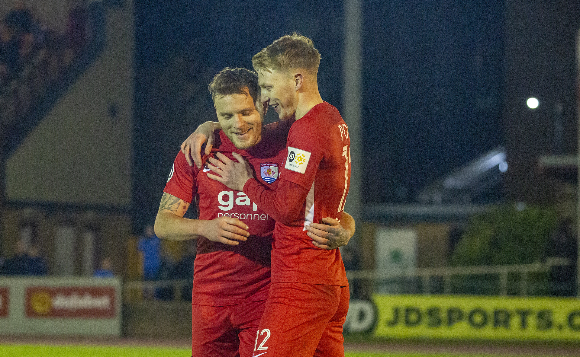 Jamie Insall and Declan Poole celebrate Kyle Smyth's own goal | © NCM Media