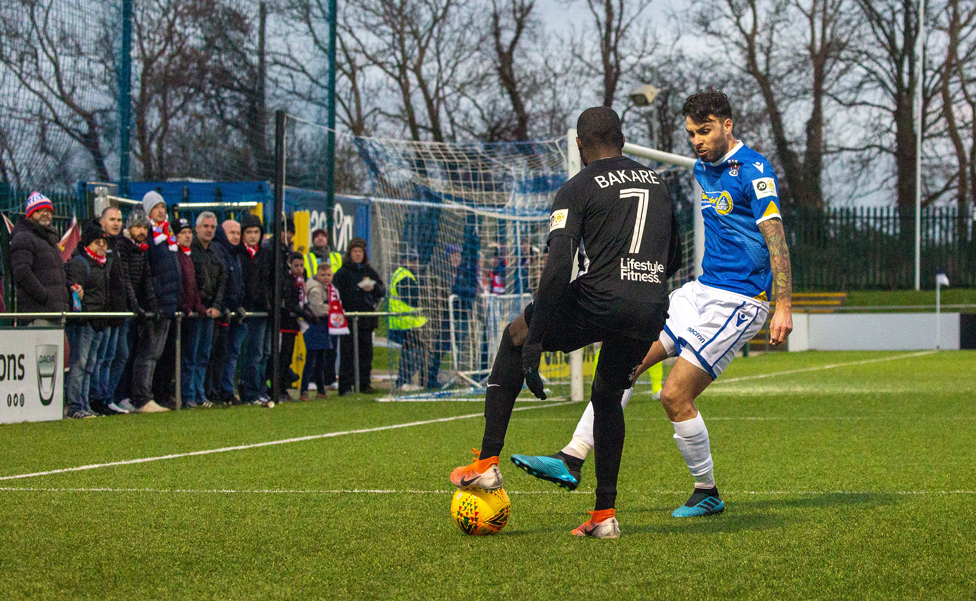 Michael Bakare goes on the attack as the travelling Nomads fans look on | Photo: Tom Houghton