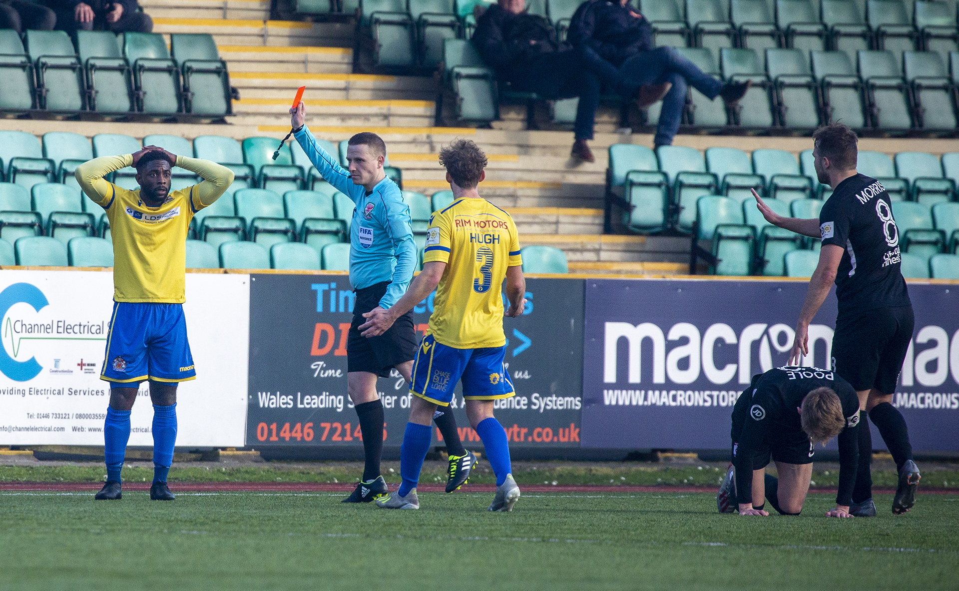 Kayne McLaggon is shown a straight red for a foul on Declan Poole | © NCM Media