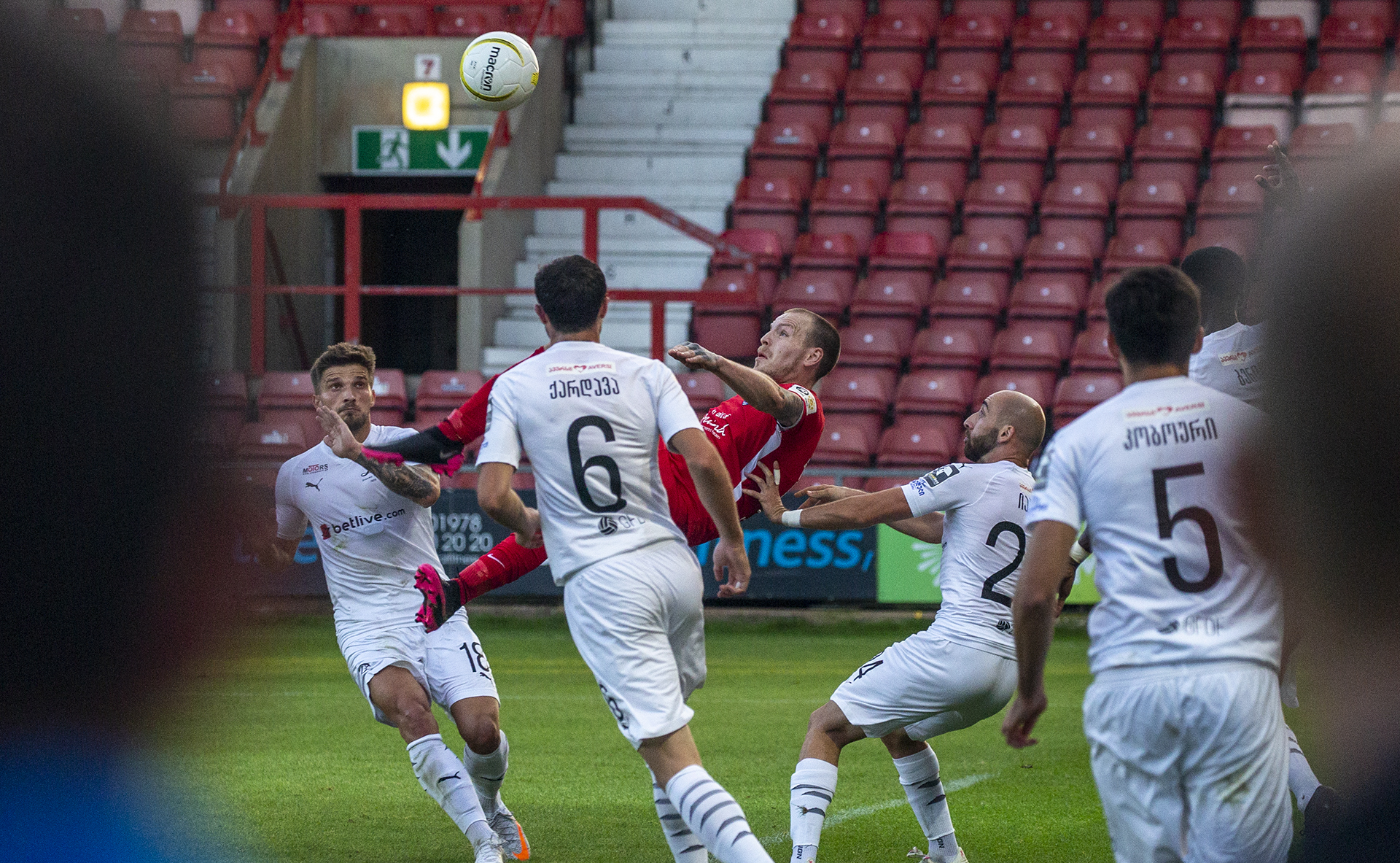 Jamie Insall acrobatically shoots for goal | © NCM Media